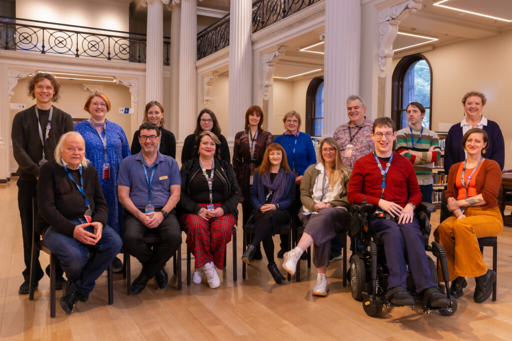 Photograph of 16 librarians in two rows, one sitting, one standing. 