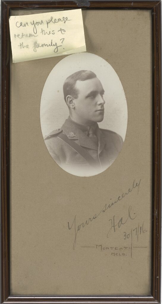A framed photograph frame featuring an oval portrait of a young soldier, wearing a World War One uniform.